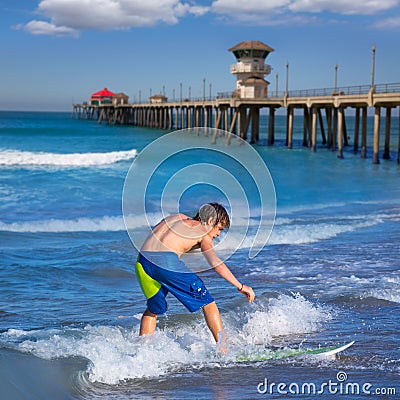 Boy surfer surfing waves on Huntinton beach Stock Photo