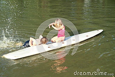 Boy swimming by a surf with girl Stock Photo