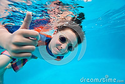 Boy swimming underwater Stock Photo