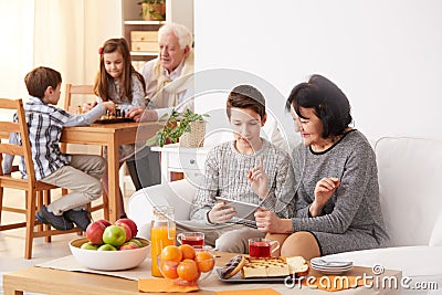 Boy teaching grandma how to use a tablet Stock Photo