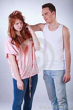 Boy teasing her female colleague Stock Photo