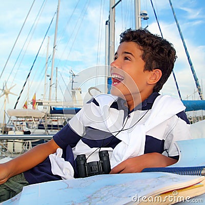 Boy teen sailor laying on marina boat chart map Stock Photo