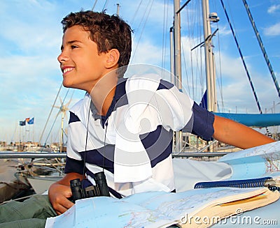 Boy teen sailorsitting on marina boat chart map Stock Photo