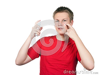 The boy, the teenager with a cream for a problem youthful skin, against spots Stock Photo