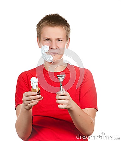 The boy, the teenager the first time tries to have a shave and is confused. Stock Photo