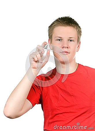 The boy, the teenager spraying fragrance perfume Stock Photo