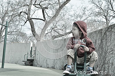 Boy on a teeter totter Stock Photo