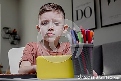 Boy is thinking about solving the problem. Mental arithmetic. Adding numbers Stock Photo