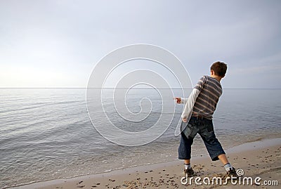 Boy Throwing Stone In Water Stock Photo