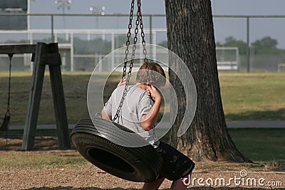 Boy on Tire Swing Stock Photo