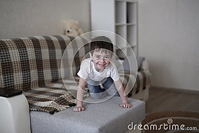 Boy toddler sad on couch in real room home Stock Photo