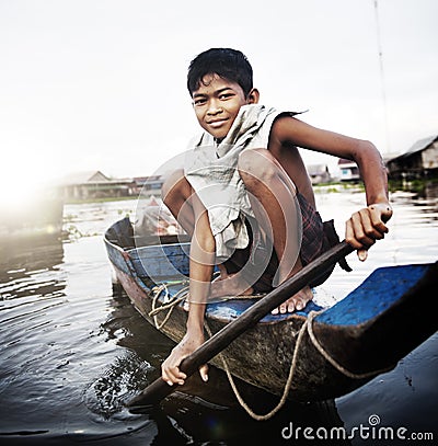 Boy Traveling by Boat in Floating Village Concept Editorial Stock Photo