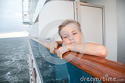 Boy traveling on ship and hold on handrails Stock Photo