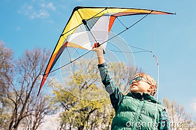 Boy try to start kite in the sky Stock Photo