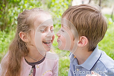 Boy trying kissing cheerful girl Stock Photo