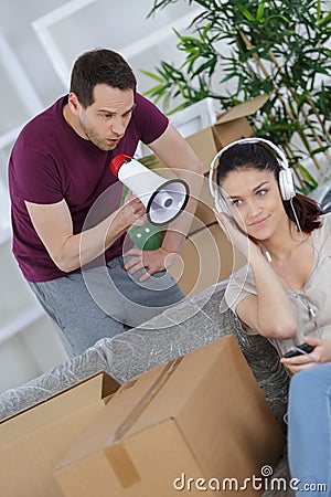 boy trying to get girls attention by shouting through loudhailer Stock Photo