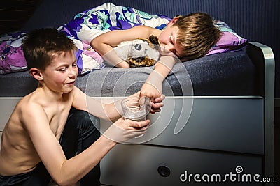 Boy trying to make his brother wet the bed Stock Photo