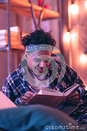 Boy unsuccessfully trying to memorizing his favorite chapters and laughing at oneself. Stock Photo