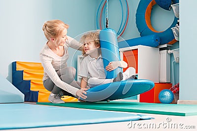 Boy using sensory integration equipment Stock Photo