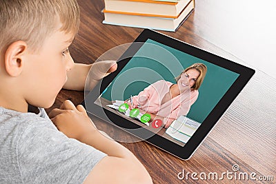 Boy Videoconferencing On Digital Tablet Stock Photo