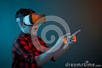 Boy in VR headset pointing on side Stock Photo