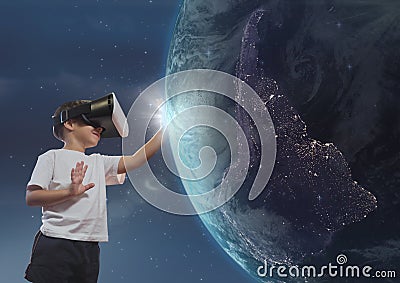 Boy in VR headset touching 3D planet against sky background Stock Photo