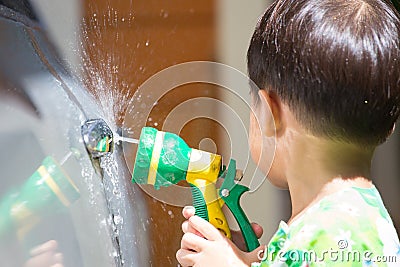 Boy washed car by water spray Stock Photo