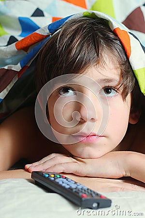 Boy watch tv with remote control Stock Photo