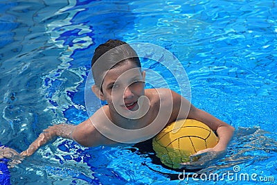 Boy with a waterpolo ball Stock Photo