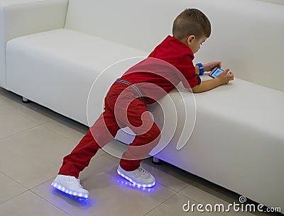 Boy wearing glowing white led sneakers Stock Photo