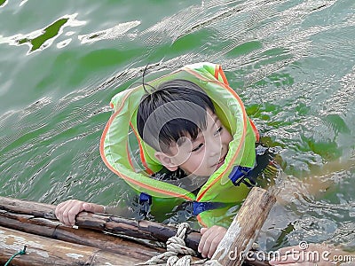 A boy wearing a life jacket to swim safely Editorial Stock Photo