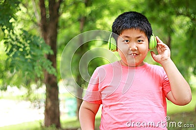 The boy wears a green headphones smiling happily Stock Photo