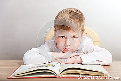 Boy in a white shirt sitting at his Desk Stock Photo