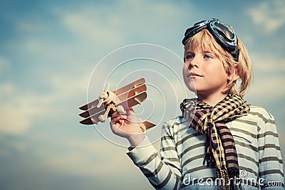 Boy with wooden plane Stock Photo