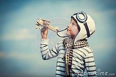 Boy with wooden plane Stock Photo