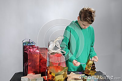 Boy wrapping up christmas gifts Stock Photo