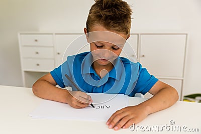 Boy writing the ABC alphabet Stock Photo