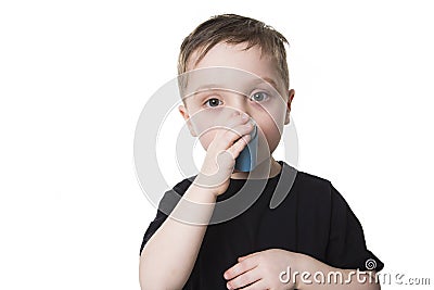 Boy 4 years old inhales himself on a white background Stock Photo