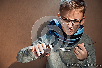 Boy 10 years was ill he did not want to drink the bitter syrup Stock Photo