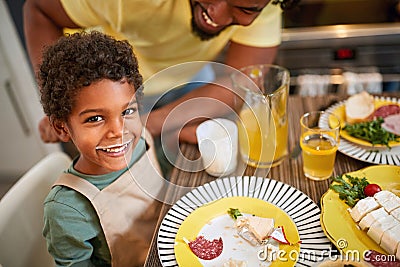 Boy with yogurt moustache having dinner Stock Photo