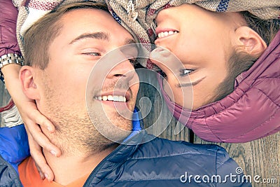 Boyfriend and girlfriend lying taking selfie outdoors with happy face expression looking each other in eyes. Couple of lovers Stock Photo