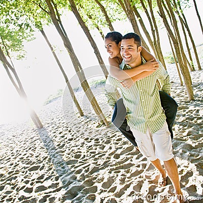 Boyfriend giving girlfriend piggy back ride Stock Photo