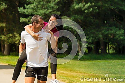 Boyfriend giving piggyback ride to girlfriend Stock Photo