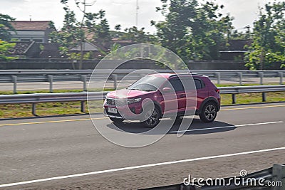 Red Honda WR-V driving fast on trans jawa highway Editorial Stock Photo