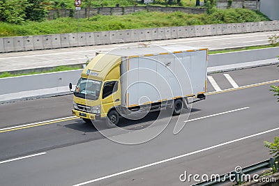 Mitsubishi Canter driving fast on the higway Editorial Stock Photo