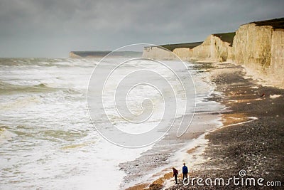 Boys on beach rough storm Desmond waves crashing beach Editorial Stock Photo