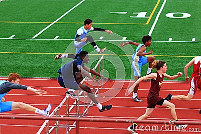 Boys competing in hurdles at a Track Competition Editorial Stock Photo