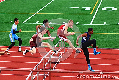 Boys competing in hurdles at a Track Competition Editorial Stock Photo