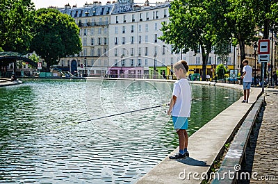 Boys fish on the side of Canal Staint-Martin in Paris Editorial Stock Photo