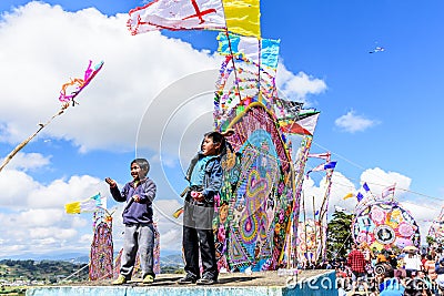 Boys fly kites in cemetery, Giant kite festival, Santiago Sacatepequez, Guatemala Editorial Stock Photo